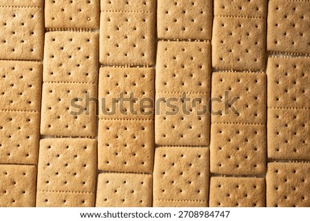 A top down view of a layer of gluten-free, dairy-free graham crackers, as a background.