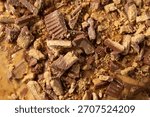 A top down view of a layer of peanut butter cup crumbles, as a background.