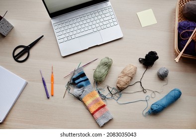 Top Down View At Layout Of Knitting Wool And Hobby Supplies On Desk, Copy Space