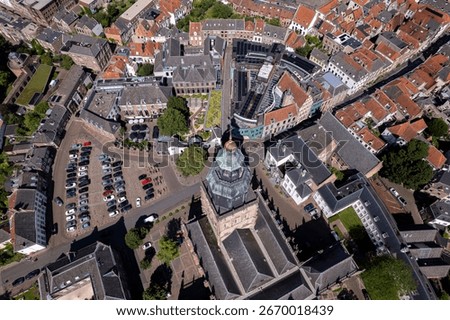 Top down view medieval authentic historic rooftops Walburgis church and surrounding city hall in Hanseatic tower town Zutphen. Europe history picturesque painterly aerial cityscape.