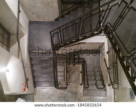 Top down view to metal stairs and concrete walls
