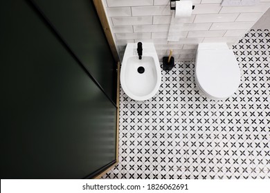 Top Down View Of A Modern Bathroom With Dark Green Closet And Retro Retro Style Black And White Floor Tiles