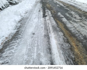 A Top Down View Of A Mostly Cleared Road Of Snow With Icy Conditions Remaining.