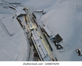A top down view of a mountainous train station (kleine Scheidegg) in the winter in the evening