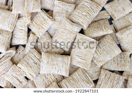 Top down view on bite size shredded wheat cereal.