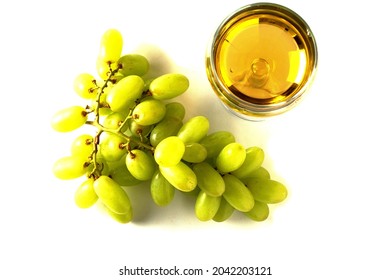 Top Down View On Glass Of White Wine And A Cluster Of Fresh Green Grapes On White Isolated Background. Produce Product. Wine Industry Concept.