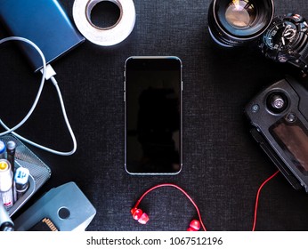 Top Down View On Phone With Modern Travel Gadgets On Black Surface