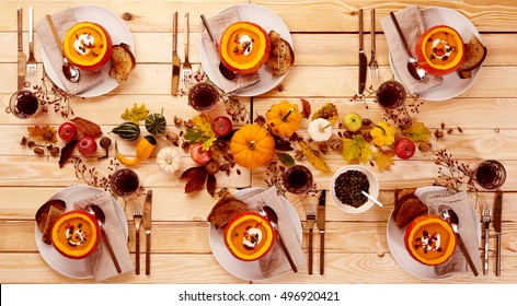 Top Down View On Place Setting Of Squash Soup In Gourds On Wooden Table. Dinner Or Lunch For A Party Of Six.