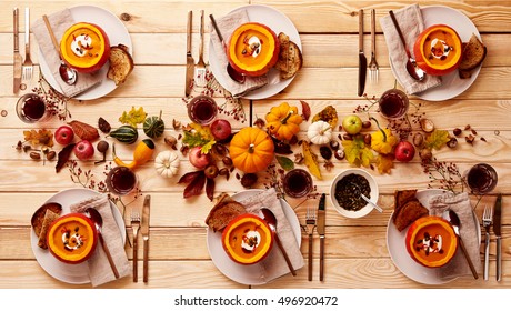 Top Down View On Place Setting Of Pumpkin Soup And Cider On Wooden Table. Dinner Or Lunch For A Party Of Six.