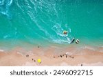 Top down view of outdoor enthusiasts enjoying jet skiing, banana boat riding and other water sports at a beautiful beach on Jibei Island, a famous tourist destination in Baisha, Penghu County, Taiwan