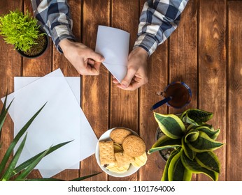 Top Down View Of Person Making Origami From Paper