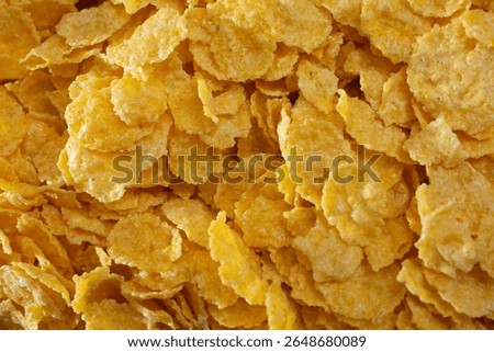 A top down view of a pile of corn flakes, as a background.