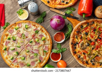 Top Down View Of Pizza With The Decoration Around It On The Wood Table Looking Delicious. Foods 