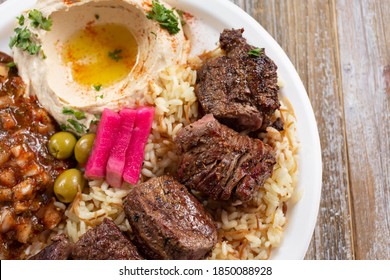 A Top Down View Of A Plate Of Beef Shish Kabob.