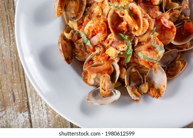 A Top Down View Of A Plate Of Fruite De Mar. This Is A Shellfish And Pasta Dish Featuring Fettuccine, Clam, And Shrimp.