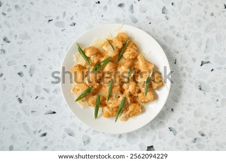 A top down view of a plate of loaded tots.