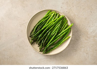 A top down view of a plate of sauteed asparagus.