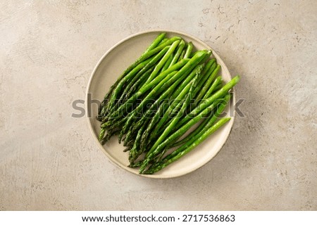 A top down view of a plate of sauteed asparagus.