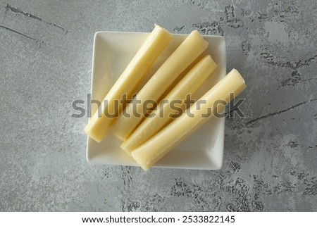 A top down view of a plate of string cheese.