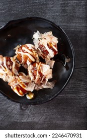 A top down view of a plate of takoyaki. - Shutterstock ID 2246470931