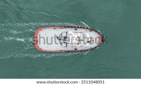 Top down view red tug boat sailing
