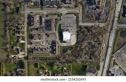 Top Down View Of Residential Area At Southern Edge Of Kenosha, Wisconsin.   Highway Construction Seen. Apartment Buildings And Single Family Homes. Area Of Trees And Shrubs And Retaining Pond. 