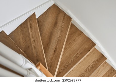 A top down view of a set of timber stairs made out of oak in a modern coastal Scandi style home.