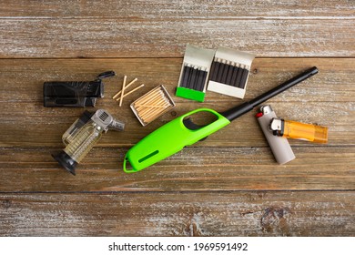 A Top Down View Of Several Options To Starting A Fire, Featuring Lighters And Matches.