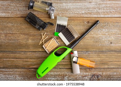 A Top Down View Of Several Options To Starting A Fire, Featuring Lighters And Matches.