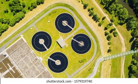 Top Down View Of Sewage Treatment Plant. Industrial Water Treatment For Big City From Drone View. Waste Water Management Background Concept.