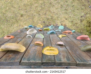 A top down view of a short rock climbing wall on the playground with grass underneath. - Powered by Shutterstock