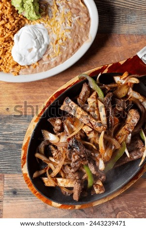 A top down view of a sizzling order of fajitas.