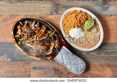 A top down view of a sizzling order of fajitas.