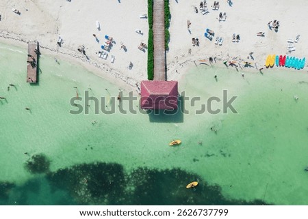 Top down view of small hut on a wooden pier at Cancun white sand beach