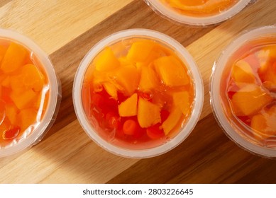 A top down view of some bubble fruit gel cups, featuring peaches and popping boba.