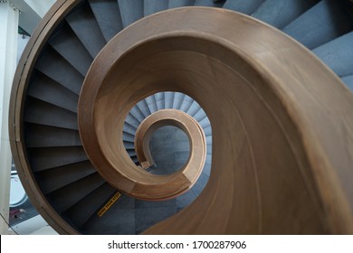 Top down view of the spiral staircase with wooden handle  - Powered by Shutterstock