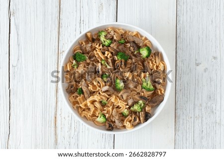 A top down view of a steak pasta entree, featuring gluten-free cascatelli pasta.