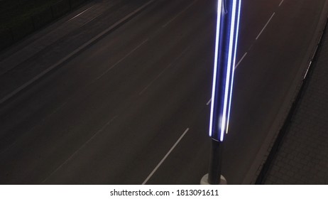 Top Down View Of The Street Lantern In The Late Evening With Driving Car. Stock Footage. Almost Empty Road Of The City Road At Night, Concept Of Transportation.