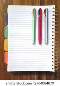Top Down View Of Text Space On Blank, Opened Notebook Page With Colorful Pens And Divider Tabs 