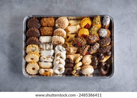 A top down view of a tray of assorted petite four cookies.