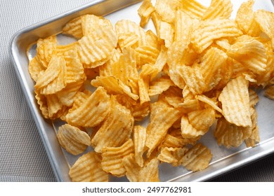 A top down view of a tray of ridged potato chips. - Powered by Shutterstock