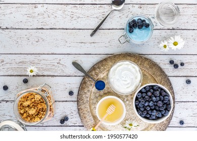 Top Down View Of A Tray Of Various Ingredients Used In Making A Blue Spirulina Yogurt Parfait.