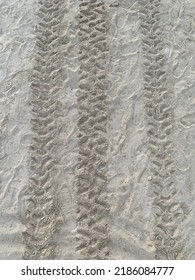 Top Down View Of Truck Tire Tracks In Sand. Wheel Motorcycle Traces  Through The Desert - Adventures Of Desert Off-road.