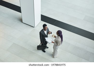 Top Down View At Two African-American Business People Chatting In Office Hall Against Graphic Floor Background, Copy Space