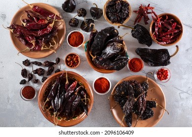 A top down view of a variety of dried chile peppers.