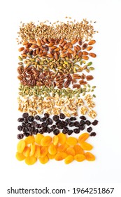 Top Down View Of Various Nuts, Seeds And Dried Fruit Used In Making Trail Mix Against A White Background.