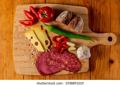 Top down view of various rustic foods on a wooden board
