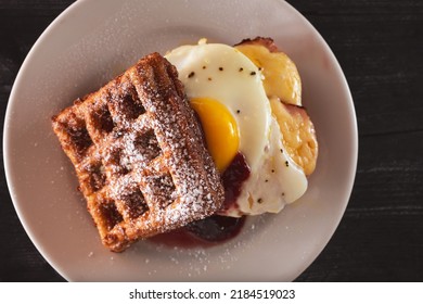 A Top Down View Of A Waffle Breakfast Sandwich.