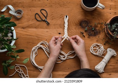 Top Down View Of Woman Making Macrame Rope Plant Hanger