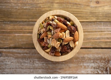 A Top Down View Of A Wood Bowl Of Trail Mix.